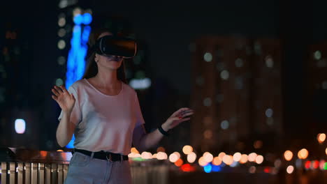 A-young-girl-in-virtual-reality-glasses-in-a-large-metropolis-simulates-work-in-the-program-game-virtual-reality-interface.-The-concept-of-augmented-reality